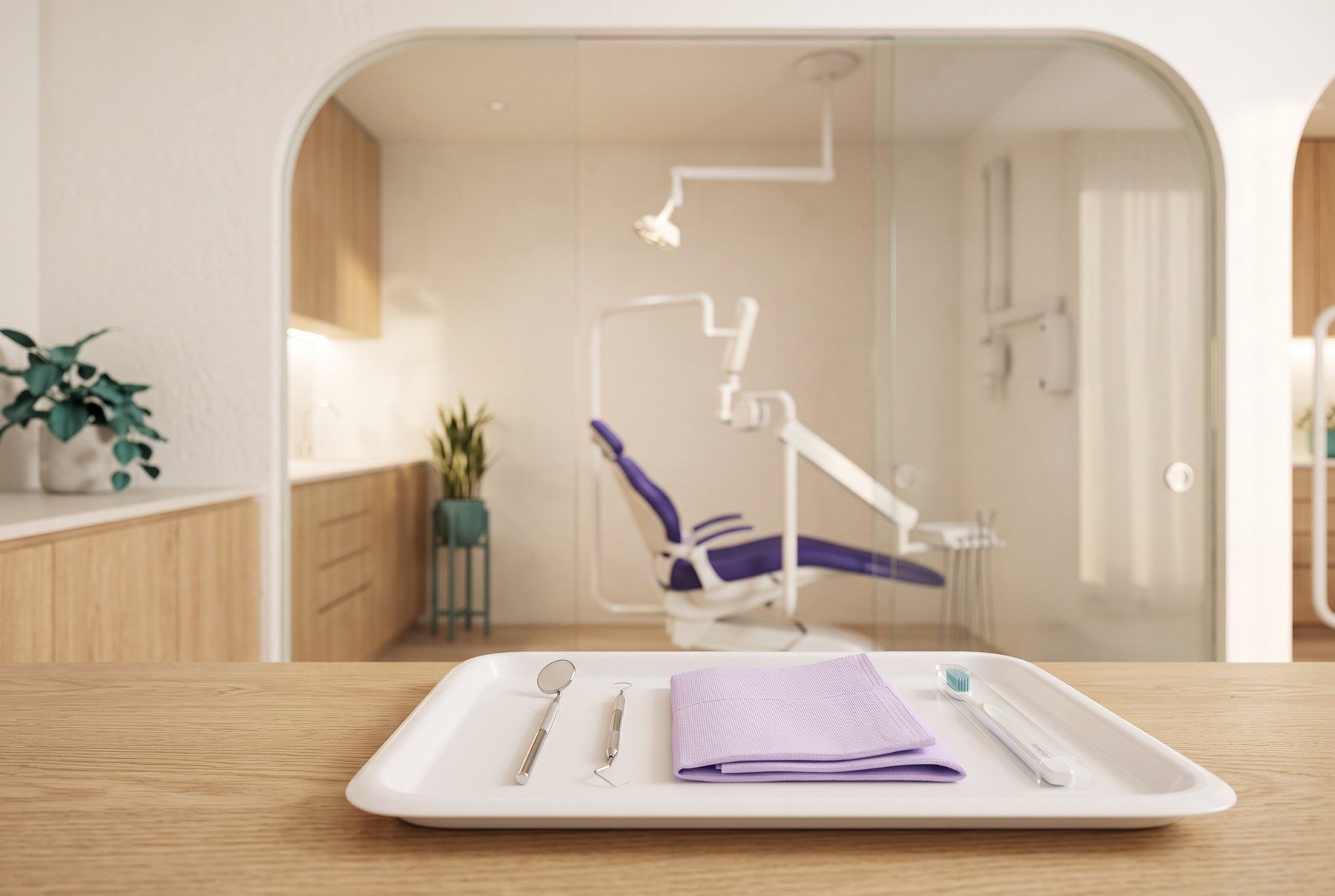 A bright treatment room with a purple dental chair, and a tray with a dental mirror and a new toothbrush